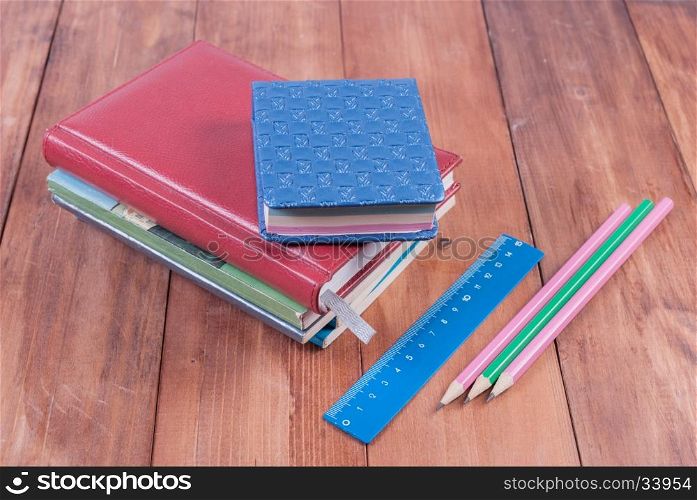 School supplies on a wooden background. Back to school.. Lying on a wooden background school supplies.