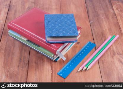 School supplies on a wooden background. Back to school.. Lying on a wooden background school supplies.