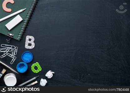 School supplies on blackboard. Back to school concept background. Copy space. Top view. Flat lay