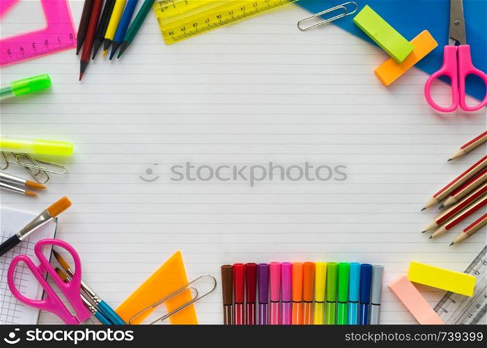 School supplies on sheet in a ruler background . Top view. Free space for text. School supplies on sheet in a ruler background . Top view