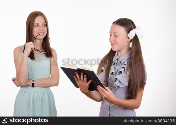 School teacher listens to the student who completed the homework