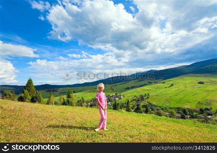 Schoolage girl in a summer mountain walk
