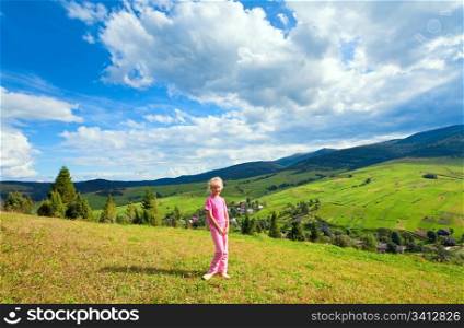 Schoolage girl in a summer mountain walk