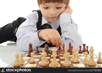 schoolboy playing chess. Isolated on white background