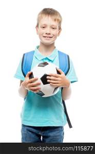 schoolboy with a soccer ball posing in the studio on a white background