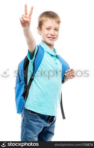 schoolboy with backpack smiling and showing a hand gesture on a white background isolated