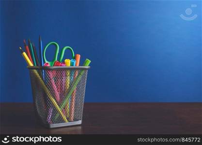 Schoolchild and student studies accessories. Back to school concept. Pencils and felt pens on blue backgroung. Copyspace. Schoolchild and student studies accessories. Back to school concept. Pencils and felt pens on blue backgroung