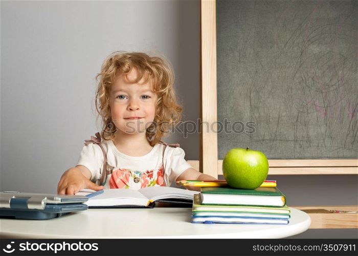Schoolchild in class against blackboard