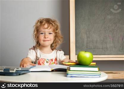 Schoolchild in class against blackboard