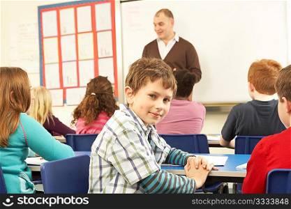 Schoolchildren Studying In Classroom With Teacher
