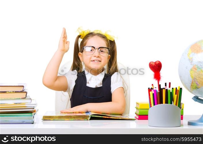 Schoolgirl at the table isolated