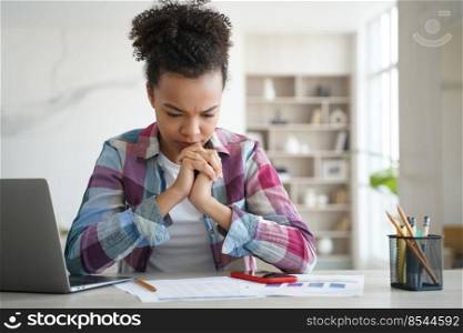 Schoolgirl has concentration problem. Overworked african american girl is studying remote at home. Teenage girl is sitting at workplace exhausted from homework. Distance learning on quarantine.. Schoolgirl has concentration problem. Overworked african american girl is studying remote at home.