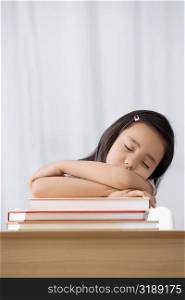 Schoolgirl sleeping at a desk in a classroom