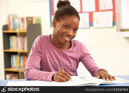 Schoolgirl Studying In Classroom