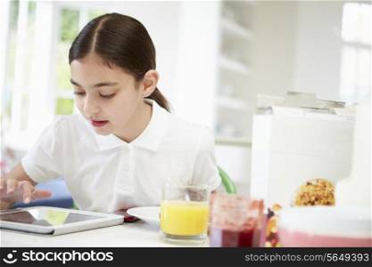 Schoolgirl With Digital Tablet At Breakfast