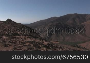 Schwenk nber Gebirge auf Fuerteventura, Serpentinen, Strasse, Passstrasse