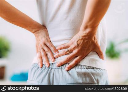 Sciatica or sciatic nerve inflammation, lower back pain. Woman with sciatic nerve pain in her lower back.. Sciatic Nerve Inflammation, Lower Back Pain