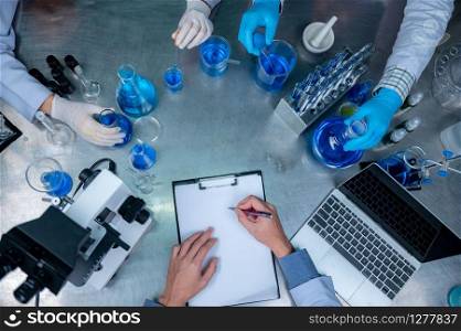 Science and medicine, scientist analyzing and dropping a sample into a glassware, experiments containing chemical liquid in laboratory on glassware, DNA structure, innovative and technology.