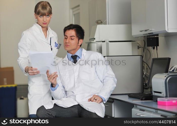 science and research biology chemistry an dmedicine youn people couple in bright modern lab