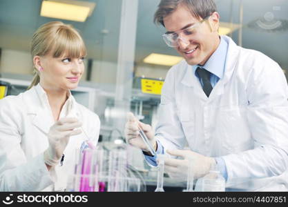 science and research biology chemistry an dmedicine youn people couple in bright modern lab