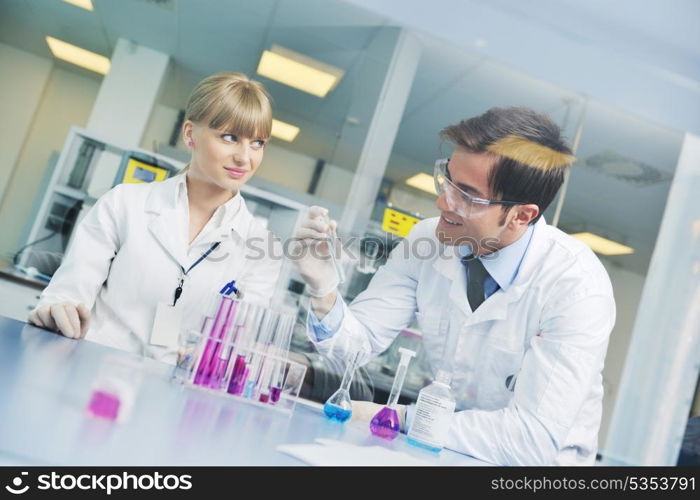 science and research biology chemistry an dmedicine youn people couple in bright modern lab