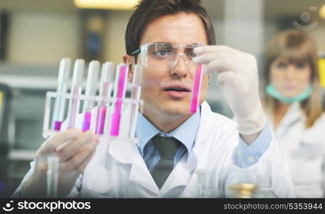 science and research biology chemistry an dmedicine youn people couple in bright modern lab