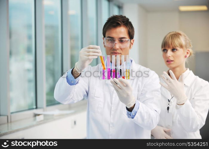 science and research biology chemistry an dmedicine youn people couple in bright modern lab