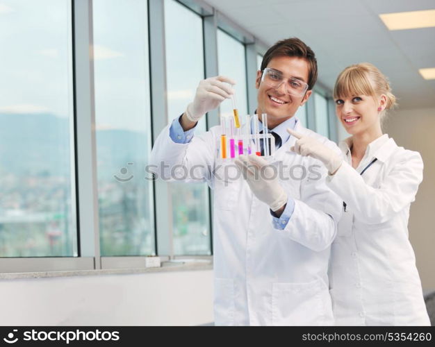 science and research biology chemistry an dmedicine youn people couple in bright modern lab