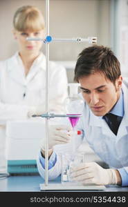 science and research biology chemistry an dmedicine youn people couple in bright modern lab