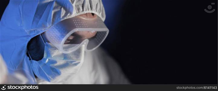 science, chemistry, biology, medicine and people concept - close up of scientist face in goggles and protective mask at chemical laboratory over dark background