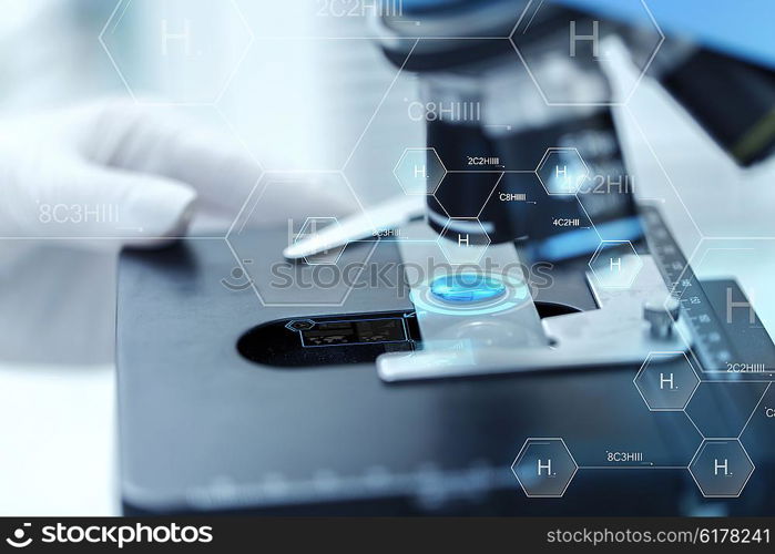 science, chemistry, biology, medicine and people concept - close up of scientist hand with test sample making research in clinical laboratory over hydrogen chemical formula