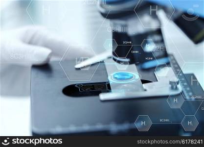 science, chemistry, biology, medicine and people concept - close up of scientist hand with test sample making research in clinical laboratory over hydrogen chemical formula