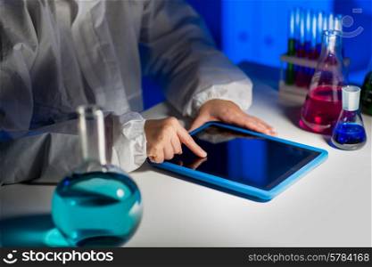 science, chemistry, medicine, technology and people concept - close up of young female scientist with tablet pc computer making test or research in laboratory