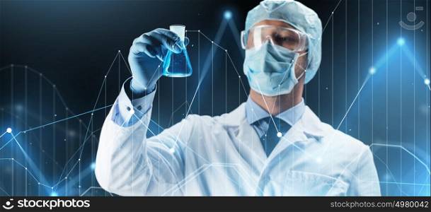 science, chemistry, research and people concept - young scientist in protective mask, hat and goggles holding test flask with chemical over dark background and virtual chart. scientist in mask holding flask with chemical