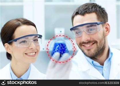 science, chemistry, research and people concept - young smiling scientists holding flask with medicine or chemical at clinical laboratory. young scientists making test or research in lab