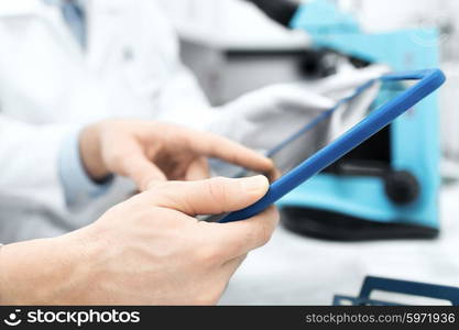 science, chemistry, technology, biology and people concept - close up of scientists hands with tablet pc in lab