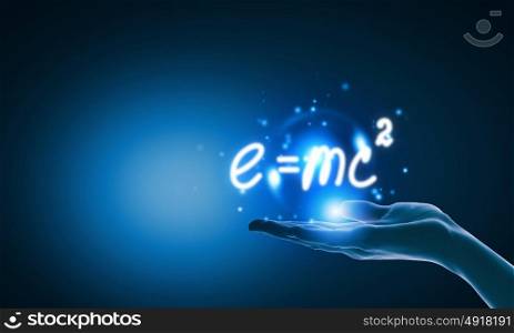 Science concept. Close up of hand holding science formula icon
