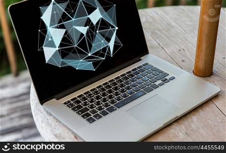 science, cyberspace and 3d technology concept - close up of open laptop computer with low poly structure on screen on table at hotel terrace