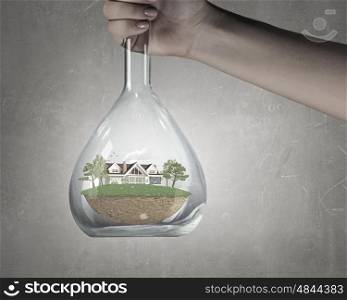 Science for green healthy life. Hand holds flask with image of green life concept