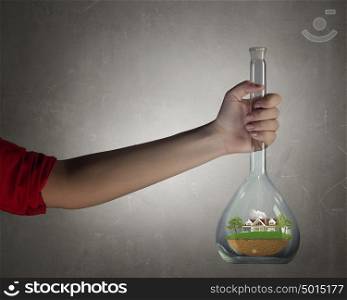 Science for green healthy life. Hand holds flask with image of green life concept