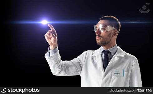 science, future technology and people concept - male doctor or scientist in white coat and safety glasses pointing finger to laser ray over black background. doctor or scientist in goggles with laser ray