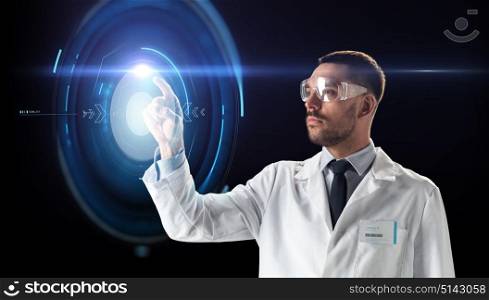 science, future technology and people concept - male doctor or scientist in white coat and safety glasses touching virtual projection over black background. scientist in goggles with virtual projection