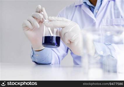 Science innovative Male medical or scientific laboratory researcher performs tests with liquid in laboratory. equipment science experiments technology Coronavirus Covid-19 vaccine research