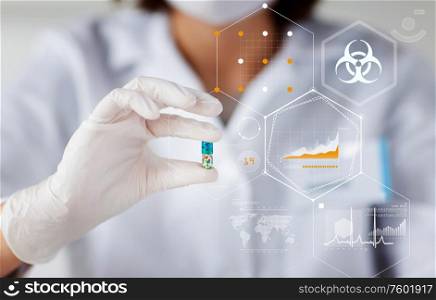 science, medicine and pandemic concept - close up of young female scientist or doctor holding and showing pill over hologram of biohazard caution sign and world map with charts. hand of scientist holding medicine pill