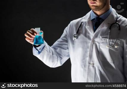 science, medicine, chemistry, pharmaceutics and people concept - close up of doctor holding flask with cure or vaccine over black background