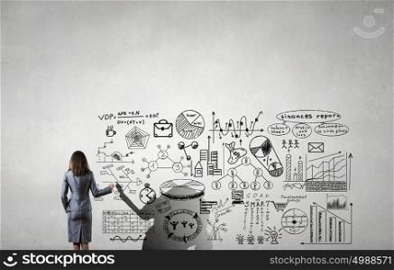 Science of business planning. Rear view of young businesswoman drawing strategy plan on screen
