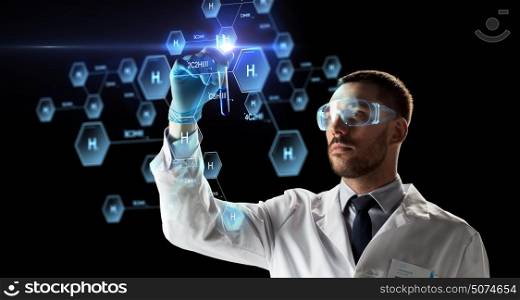 science, research and chemistry concept - young scientist in safety glasses with test tube and virtual projection of chemical formula. scientist with test tube and chemical formula