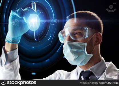 science, research and people concept - young scientist in safety glasses and face mask with test tube and virtual projection. scientist with test tube and virtual projection