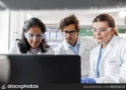 science research, work and people concept - international team of scientists with laptop computer working in laboratory. scientists with laptop working in laboratory