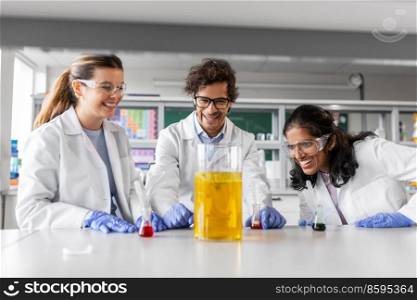 science research, work and people concept - international team of scientists with chemicals working in laboratory. scientists with chemicals working in laboratory